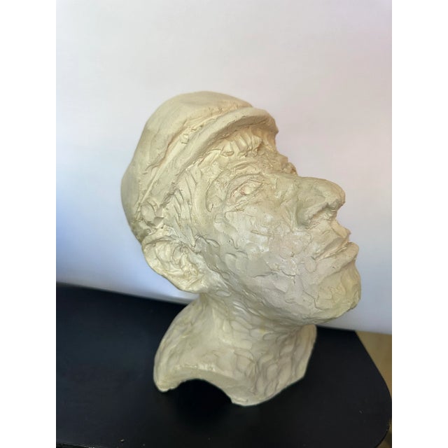 Handmade clay bust of a man with a cap. Signed by the artist.