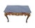 A striking Italian-style painted and parcel-gilt console table featuring an elegant marble top and richly carved...