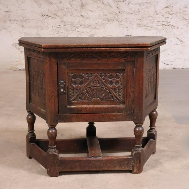 This 19th Century English Oak Credence Table is a distinguished antique that embodies the solid craftsmanship and...