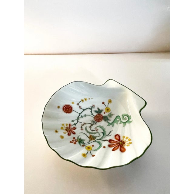 A beautiful abstract floral pattern seashell trinket dish with green trim. Perfect for your desk, dresser or bath vanity.
