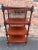 This is a beautiful mid 19th century English etagere with four shelves. Nicely turned legs resting on the original brass...