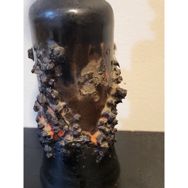 Beautiful gilt Icelandic lava vase. The vase is handmade and glazed green with fragments of volcanic lava forming a...