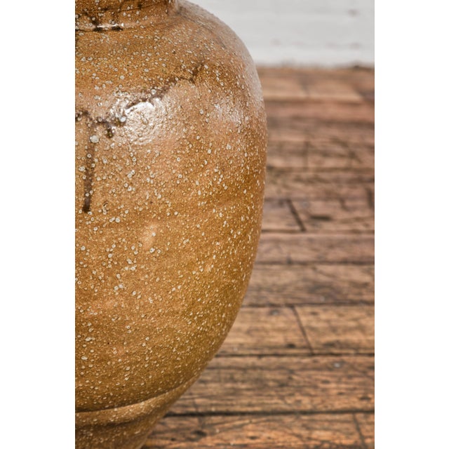 A Japanese Taishō period sand glaze vase from circa 1900 with touches of brown dripping. This captivating vase from the...