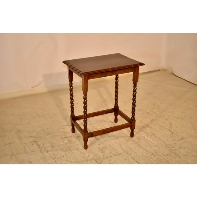 Circa 1900 Edwardian oak side table from England. The top has an amazing edge. It is double beveled and scalloped for a...