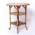 Standout 19th century English three tiered stand handcrafted in burnt bamboo having an octagon top decorated with flowers...