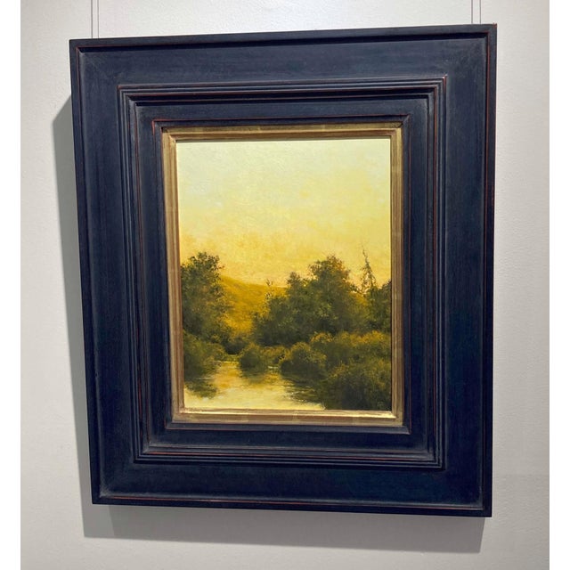 The Last Sunset captures a serene landscape bathed in warm, golden hues as the sun dips below the horizon. Lush foliage...