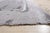 A hand-knotted wool rug, made in India and measuring 5' x 8'. Loose, abstract drawing rather than a formal repeating...