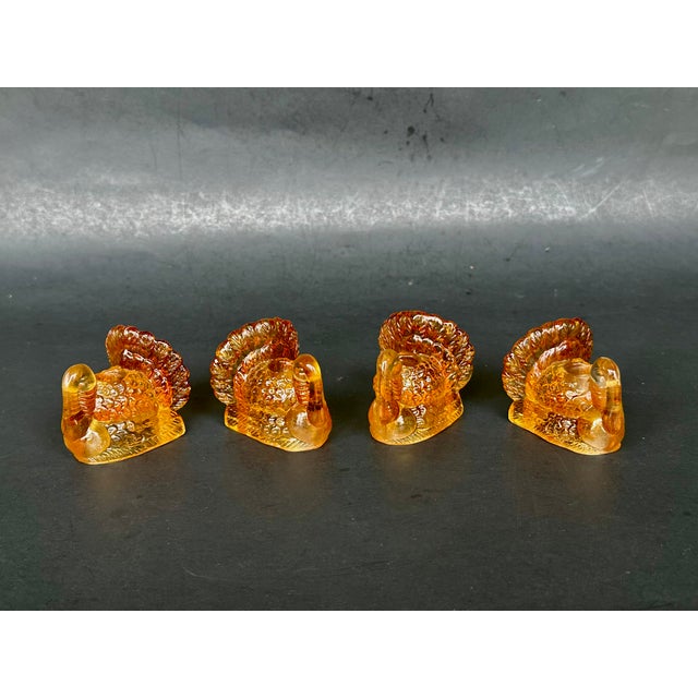 Add a festive touch to your Thanksgiving dinner table with this set of four amber glass turkey candlestick holders. The...