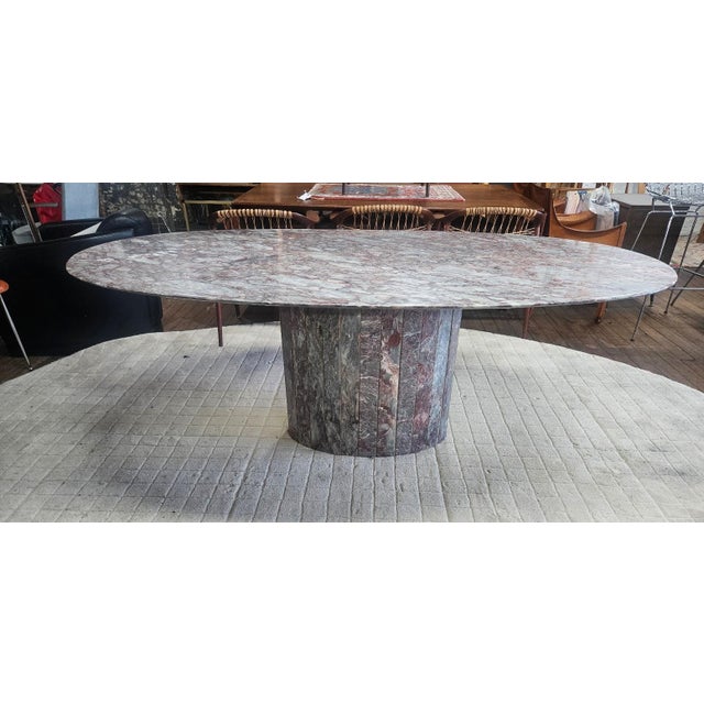 This exotic marble dining table showcases a breathtaking array of natural veining, seamlessly blending rich earthy tones,...