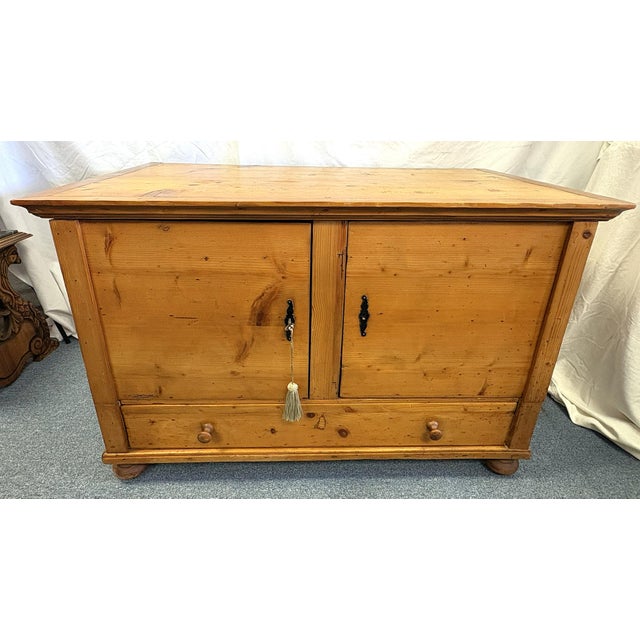 Great rustic primitive pine cabinet from the early 20th century. It is crafted of pine with chunky dovetail joints and...