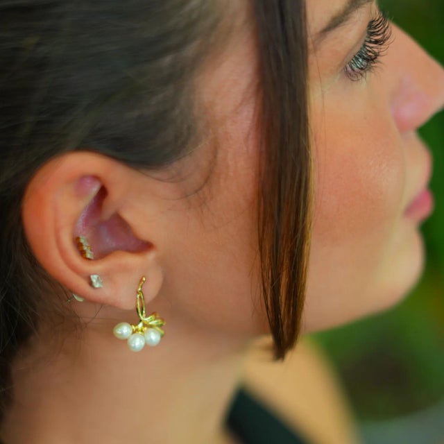 Bridal Pearl & Gold Dangle Earrings These exquisite earrings feature delicate 18k gold-plated leafy branches, that flow...