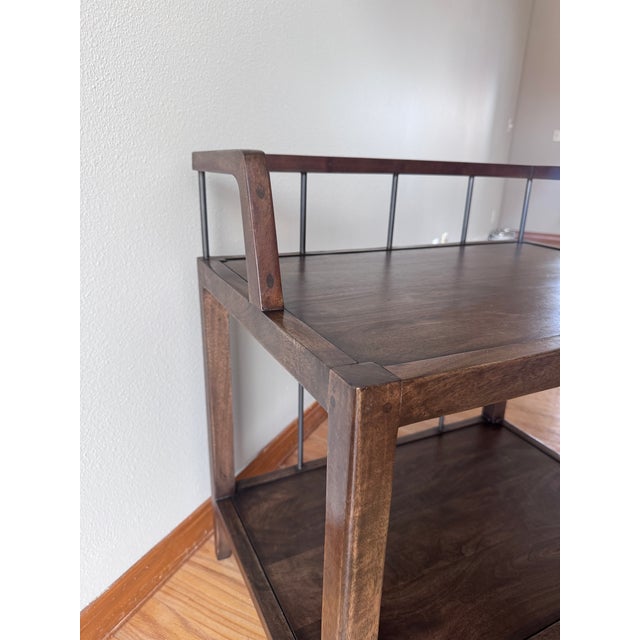A distinctive matching pair of Howard Nightstands by Four Hands, featuring warm Pecan-finished wood and slender metal...