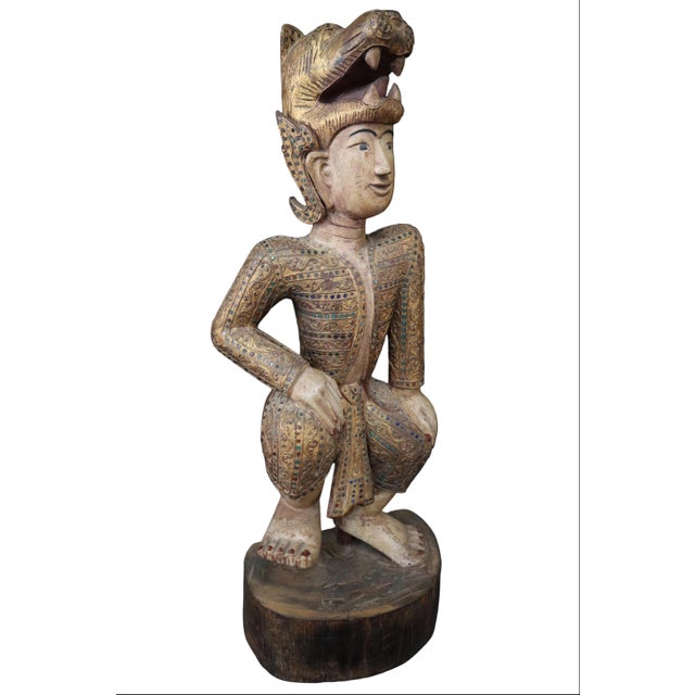 This charming hand painted wooden statue exemplifies traditional Burmese craftsmanship with its dazzling mosaic elements...