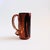 A vintage studio pottery mug. Lovely natural colored glazes in earthy reddish brown and gray. Features hand painted...