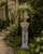 A weathered late-20th-century garden pedestal cast in concrete and modeled after a classical Corinthian column. Its...