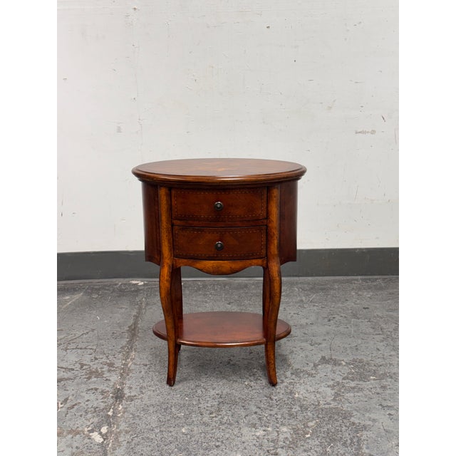 Design Plus Gallery presents an Oval Double Drawer Side Table by unknown brand. Constructed of wood and veneer, this table...