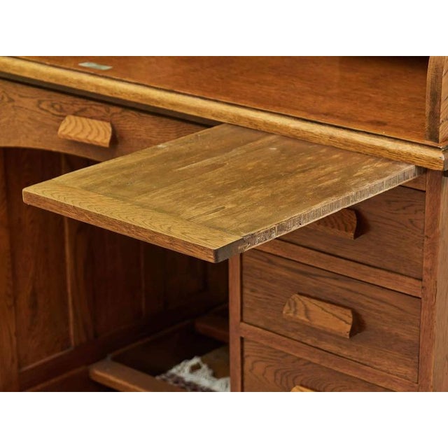 Completely restored American desk with a lockable top. Solid oak desk from the early 20th century with a practical roller...