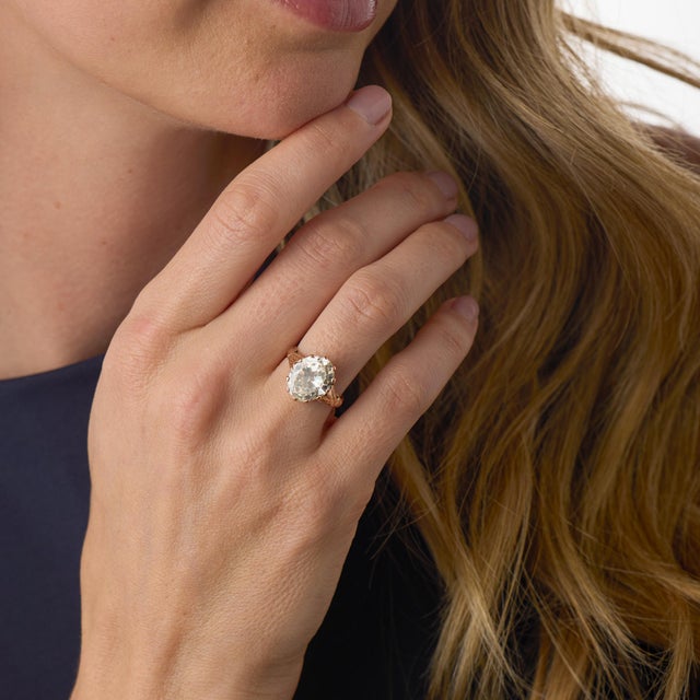 This remarkable Victorian engagement ring centers on an impressive 4.06 carat antique oval cut diamond, certified by GIA...