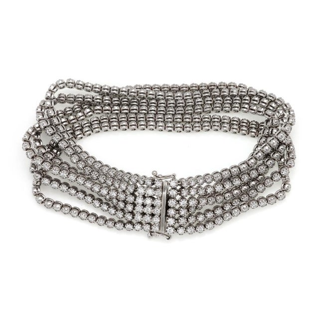 This is a gorgeous Estate bracelet, crafted from 18k white gold featuring 6 strands of prong set round cut diamonds, all...
