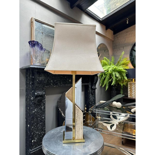 A large skyscraper style table lamp by Sciolari, in Travertine, Chrome and Brass. Signature cast into the base as seen in...