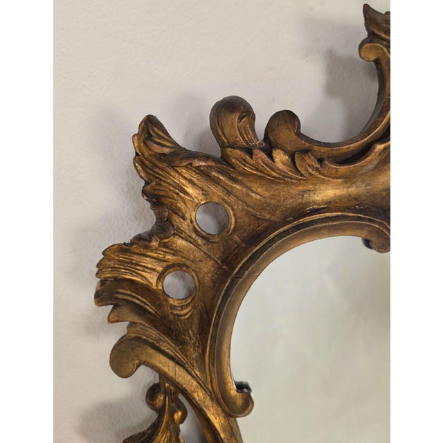 A classic George III Chippendale design hand carved gilt-wood mirror made in England around 1920.