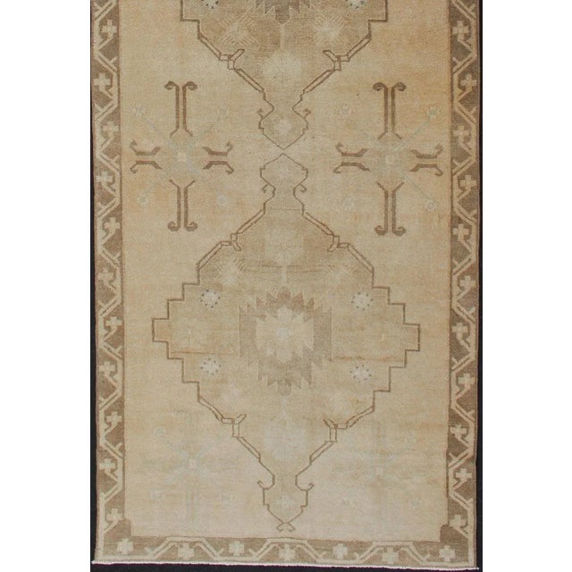 wide and long vintage Turkish Oushak runner in neutral colors with medallions in taupe, blue and light brown. rug/....