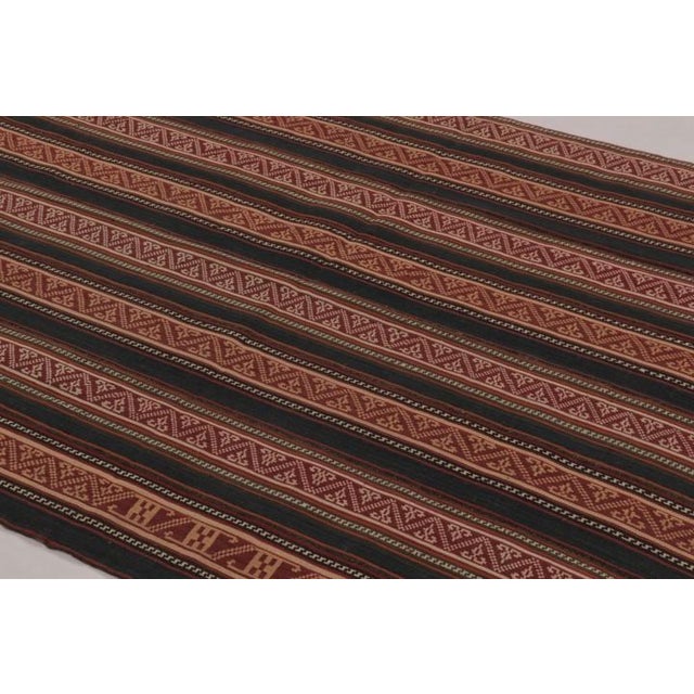 Handwoven in wool and originating circa 1950-1960, this 5x6 vintage Persian kilim is a newly curated tribal addition to...