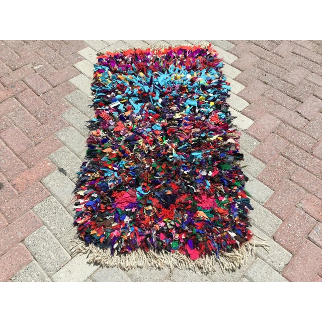 Vintage, handwoven Turkish shaggy rug is approximately 40 years old. It is handmade of wool and recycled fabric. It has...