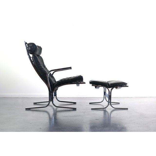 Both comfortable and stately, this lounge chair and ottoman have exceptional architectural lines in a design reministent...