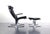 Both comfortable and stately, this lounge chair and ottoman have exceptional architectural lines in a design reministent...