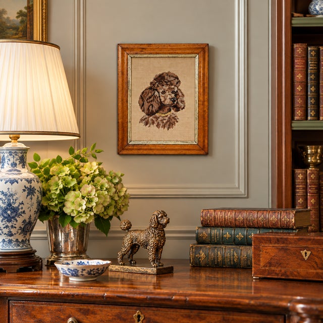 A vintage needlepoint portrait of a beautifully groomed poodle, worked in a sophisticated palette of chocolate brown,...