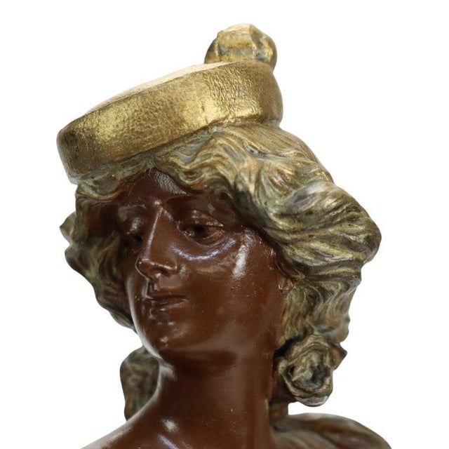 A pair of 19th-century Art Nouveau bronze decorative bases titled “Carmen” and “Mignon” in raised lettering. Each cast...