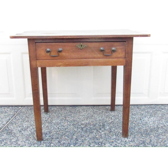 Antique English elmwood side table, c.1870 Having a well figured rectangular top, below which is a single long drawer and...