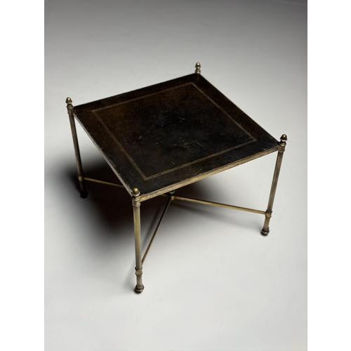 Side table/coffee table. Originally from France, mid-20th century. In the style of Maison Bagues. Top inlaid with leather...