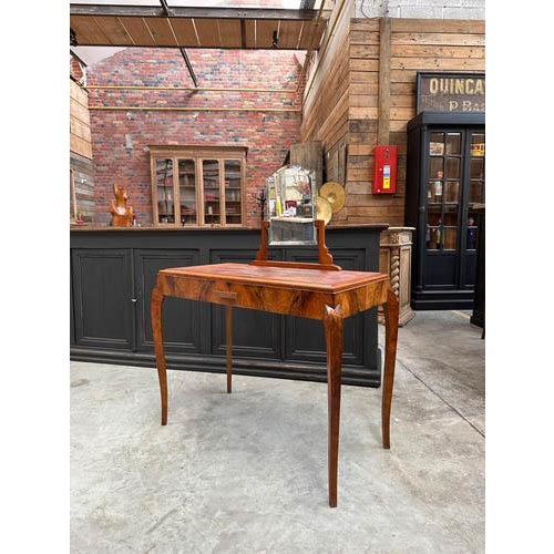 Antique early 20th-century burr-walnut dressing table It features a large functional compartmentalized drawer with copper...