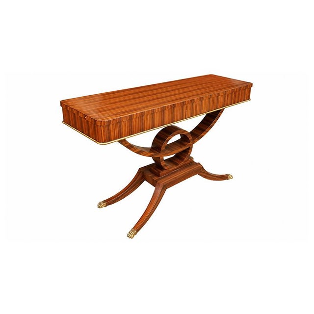 An elegant console table with strong Art Deco influences, featuring a refined burl veneer in warm amber tones and a...