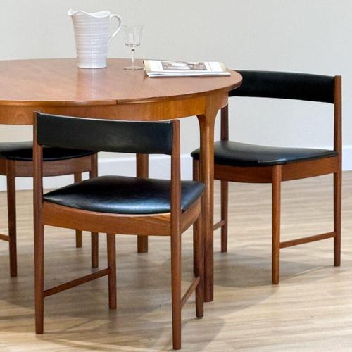 A refined expression of mid-century craftsmanship, this round extending dining table with four chairs was designed by Tom...