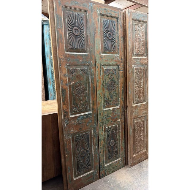 Elevate your space with this exquisite hand-carved floral wood barn door, a stunning architectural statement crafted from...