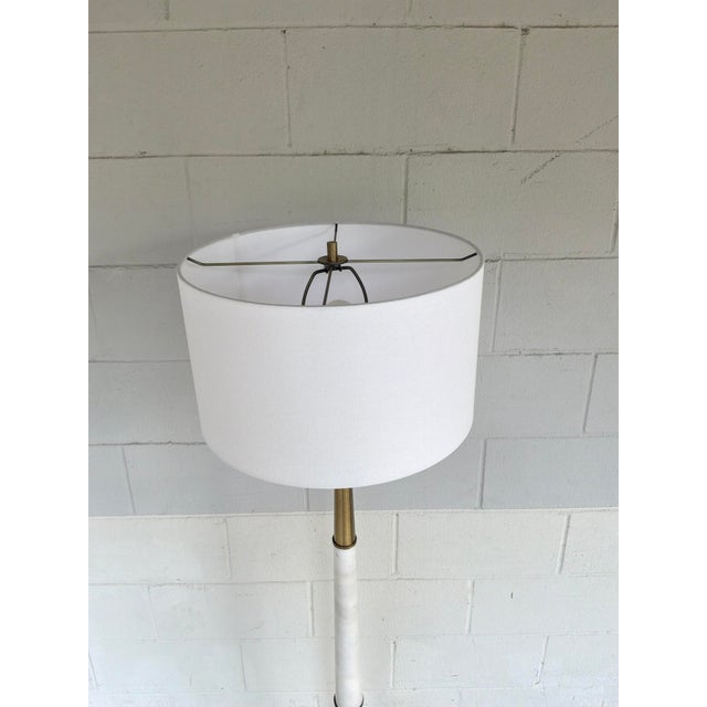 Modern Uttermost Faro Floor Lamp. Marble & Brass, Skinny body with gold base. Original retail $747. Showroom floor sample.