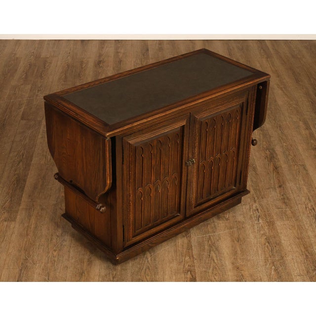 High Quality Vintage Oak Bar Cabinet with Drop-Leaf Sides and Sculpted Cupboard Doors, Mounted on Rolling Casters