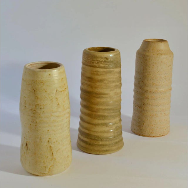 Three-cylinder Studio Pottery vases in white tones are very sculptural with a natural rough character created on the...