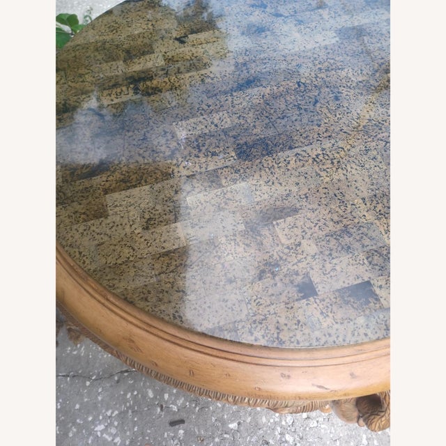 Round table with stone clad top, based with three carved wood figural wings swans making up the skirt and legs. This...