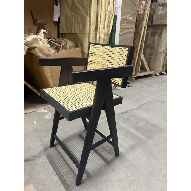 Counter-height armed stool with diamond weave Viennese cane seat and back, available in teak, black, or natural. Suitable...