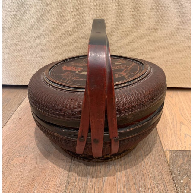 Turn-of-the-century Chinese woven basket with bamboo handle and painted decoration of some festivities
