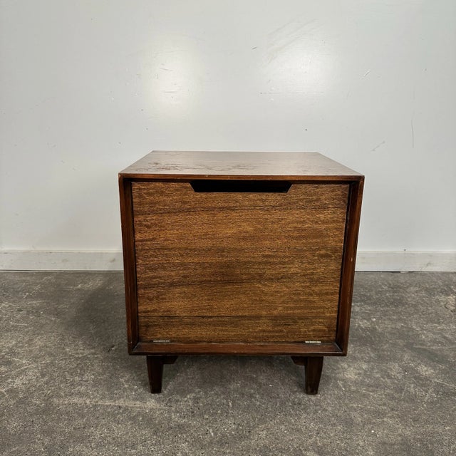Milo Baughman for Drexel perspective nightstand constructed out of primavera wood with a drop front that opens to reveal...
