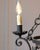 A refined 20th-century French wrought iron chandelier featuring elegant craftsmanship and a graceful, architectural...