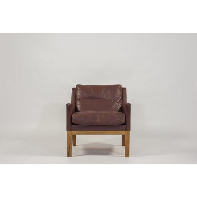 Elegant armchair designed by Kai Lyngfeldt Larsen in the 1960s. The armchair has a solid rosewood frame upholstered in...