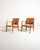 Set of two armchairs with a teak frame, contoured armrests, and tapered legs. Padded seat and backrest, upholstered in...