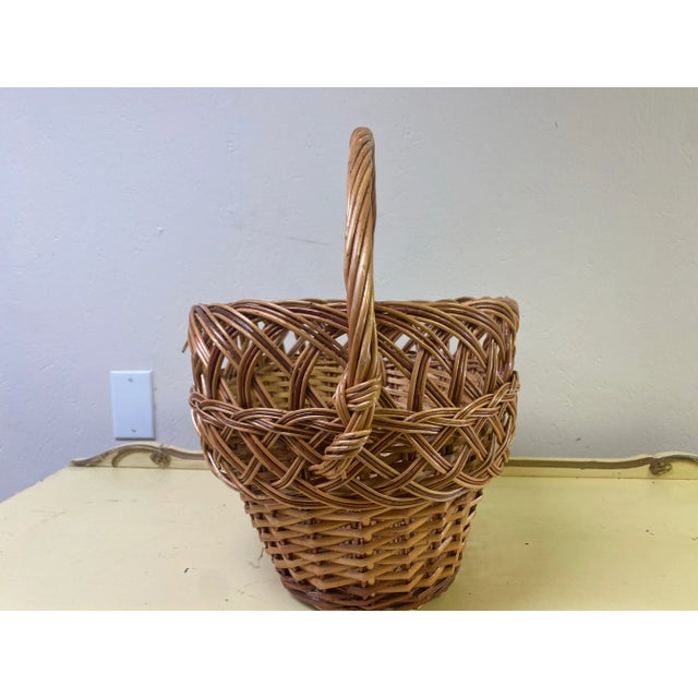 Antique French Provincial Grape Harvest Basket with single handle. One break in wicker on the twisted handle. The basket...