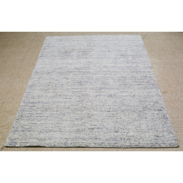 Indian Light Blue Hand-knotted with care using traditional rug-making techniques, this wool rug blends timeless...